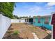 View of backyard with fence and shed, and back of home at 9015 Mark Twain Ln, Port Richey, FL 34668