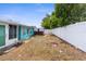 Exterior shot with fence, grass, shed and the back of the house at 9015 Mark Twain Ln, Port Richey, FL 34668