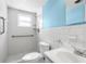 Bathroom with grab bars, tile surround and a window for natural light at 9015 Mark Twain Ln, Port Richey, FL 34668