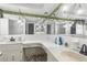 This bathroom has dual sinks, and bright lighting at 9015 Mark Twain Ln, Port Richey, FL 34668