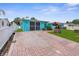 Charming home with a brick driveway, well-kept lawn, and vibrant blue exterior at 9015 Mark Twain Ln, Port Richey, FL 34668