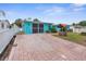 Turquoise home with a brick driveway and a well at 9015 Mark Twain Ln, Port Richey, FL 34668