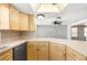 Kitchen features light wood cabinets and white countertops at 9015 Mark Twain Ln, Port Richey, FL 34668