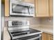 Kitchen with stainless steel microwave and electric range at 9015 Mark Twain Ln, Port Richey, FL 34668
