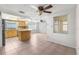 Open kitchen and dining area with tile floors, a ceiling fan, and lots of natural light at 9015 Mark Twain Ln, Port Richey, FL 34668