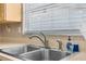 Kitchen sink with stainless steel faucet, window and beige countertops at 9015 Mark Twain Ln, Port Richey, FL 34668