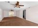 Spacious living room with carpet flooring and sliding glass doors at 9015 Mark Twain Ln, Port Richey, FL 34668