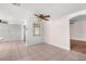Spacious living room featuring tile flooring, ceiling fan and natural light at 9015 Mark Twain Ln, Port Richey, FL 34668