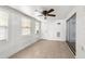 A bright living room with neutral tiled floor and ceiling fan at 9015 Mark Twain Ln, Port Richey, FL 34668