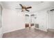 Bright living room with tile flooring, ceiling fan and easy access to other areas at 9015 Mark Twain Ln, Port Richey, FL 34668