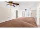 The cozy living room has neutral walls, carpet, and a sliding glass door at 9015 Mark Twain Ln, Port Richey, FL 34668