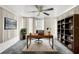 Well-lit home office with modern desk, ample storage, and stylish decor for productivity at 9015 Mark Twain Ln, Port Richey, FL 34668