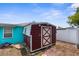 Backyard shed with brick pathway stones and stepping stones at 9015 Mark Twain Ln, Port Richey, FL 34668