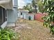 Fenced backyard featuring a storage shed and room for outdoor activities at 9034 Cochise Ln, Port Richey, FL 34668