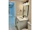 Bathroom with modern vanity, black hardware, rectangular mirror, and modern lighting at 9034 Cochise Ln, Port Richey, FL 34668