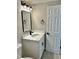 Bathroom with new vanity, rectangular mirror, and modern light fixture at 9034 Cochise Ln, Port Richey, FL 34668