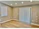 Cozy bedroom featuring neutral walls, new floors and vertical blinds at 9034 Cochise Ln, Port Richey, FL 34668