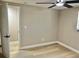 Bedroom with wood floors, ceiling fan, and ensuite bathroom access at 9034 Cochise Ln, Port Richey, FL 34668