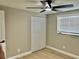 Bedroom with a ceiling fan, light wood floors, and closet with bi-fold doors at 9034 Cochise Ln, Port Richey, FL 34668