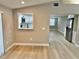 View of renovated kitchen from the dining area with new flooring and stainless appliances at 9034 Cochise Ln, Port Richey, FL 34668