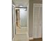Hallway with modern lighting and closet featuring shutter-style doors at 9034 Cochise Ln, Port Richey, FL 34668