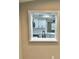 Renovated kitchen as viewed through pass-through window; features white cabinetry and quartz countertops at 9034 Cochise Ln, Port Richey, FL 34668