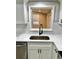 Modern kitchen sink area with black faucet, stainless sink, white countertops, and tiled backsplash at 9034 Cochise Ln, Port Richey, FL 34668