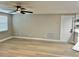 Open living area with tile floors and a door leading to another room at 9034 Cochise Ln, Port Richey, FL 34668