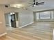 Open-concept living space with tiled flooring and kitchen access at 9034 Cochise Ln, Port Richey, FL 34668