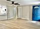 Spacious living room featuring modern flooring, a blue front door and lots of light at 9034 Cochise Ln, Port Richey, FL 34668
