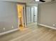 Main bedroom features light hardwood flooring, three closets and an ensuite at 9034 Cochise Ln, Port Richey, FL 34668