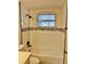 Bathtub and shower featuring white tile, accent tiles, and black shower head at 9034 Cochise Ln, Port Richey, FL 34668