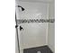 Walk-in shower featuring mosaic tile accent and a modern black shower head at 9034 Cochise Ln, Port Richey, FL 34668