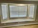 Bay window with built-in bench seat and mini blinds at 9034 Cochise Ln, Port Richey, FL 34668