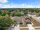 Aerial view of a suburban neighborhood featuring well-manicured lawns and mature trees at 9048 Southern Charm Cir, Brooksville, FL 34613