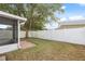 Large backyard with well maintained lawn and white privacy fence at 9048 Southern Charm Cir, Brooksville, FL 34613