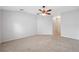 Spacious bedroom featuring neutral carpet, ceiling fan, and bright natural light at 9048 Southern Charm Cir, Brooksville, FL 34613