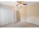 Bedroom featuring carpet, ceiling fan, closet, and doorway to hall at 9048 Southern Charm Cir, Brooksville, FL 34613