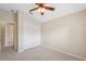 Cozy bedroom with neutral carpet, ceiling fan, and closet with double doors at 9048 Southern Charm Cir, Brooksville, FL 34613