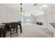 Spacious dining room area with modern lighting fixtures and seamless flow to the living area at 9048 Southern Charm Cir, Brooksville, FL 34613