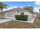 Charming single Gathering home with a well maintained lawn and an attached two car garage at 9048 Southern Charm Cir, Brooksville, FL 34613