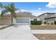 Charming single Gathering home with a well maintained lawn and an attached two car garage at 9048 Southern Charm Cir, Brooksville, FL 34613