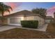 Charming single Gathering home with a well maintained lawn and an attached two car garage at 9048 Southern Charm Cir, Brooksville, FL 34613