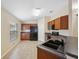 Functional kitchen featuring dark appliances, ample cabinetry, and smooth transition to the dining area at 9048 Southern Charm Cir, Brooksville, FL 34613