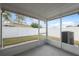 Screened patio featuring concrete floor, views of backyard, and white privacy fence at 9048 Southern Charm Cir, Brooksville, FL 34613