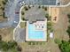 Overhead view of a community pool with lounge chairs and a nearby playground at 9048 Southern Charm Cir, Brooksville, FL 34613