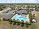 Community swimming pool area with lounge chairs, tables, and playground at 9048 Southern Charm Cir, Brooksville, FL 34613