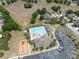 Aerial view of community pool, playground, and parking lot, surrounded by trees at 9048 Southern Charm Cir, Brooksville, FL 34613