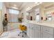 Bright bathroom with white cabinets, a stand-alone tub, and dual sinks at 9245 Grand Cypress Dr, Spring Hill, FL 34613