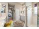 Bright bathroom features a glass-enclosed shower, double sinks, and neutral tile flooring at 9245 Grand Cypress Dr, Spring Hill, FL 34613